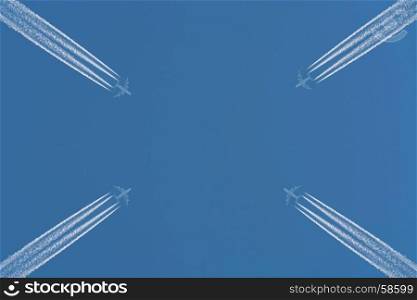 Three planes flying at high altitude. Contrails against a dark blue sky.