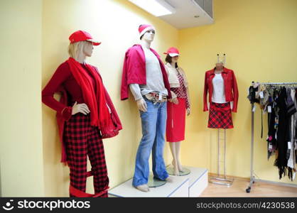 Three plastic mannequins in clothing store - female and male
