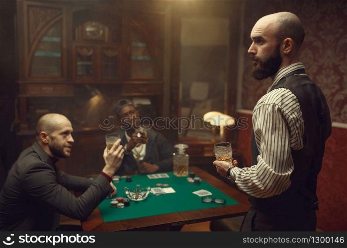 Three poker players sitting at the table in casino. Games of chance addiction, gambling house,. Three poker players sitting at the table, casino