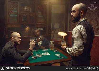 Three poker players sitting at the table in casino. Games of chance addiction, gambling house,. Three poker players sitting at the table, casino