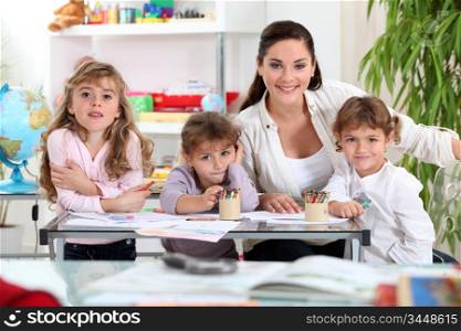 three primary schoolgirls and a teacher