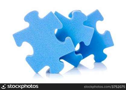 Three puzzle pieces with reflection on white background
