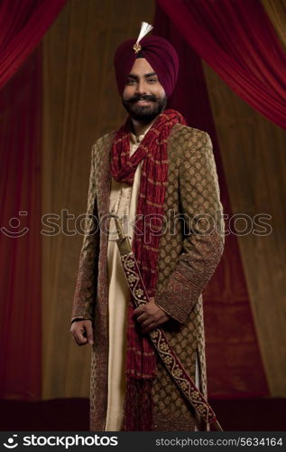 Three quarter length of mid adult man wearing wedding dress