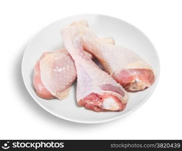 Three Raw Chicken Legs On White Plate Isolated On White Background