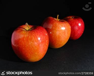 Three red apples bright in a row
