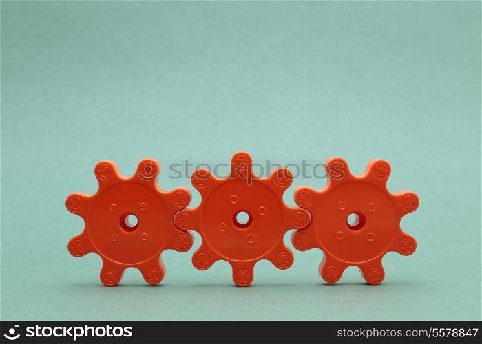 three red plastic gears