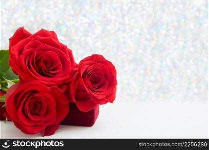 Three Red Roses and jewelery present box with boke Background. copy space - Valentines and 8 March Mother Women&rsquo;s Day concept. Three Red Roses and jewelery present box with boke Background. copy space - Valentines and 8 March Mother Women&rsquo;s Day concept.