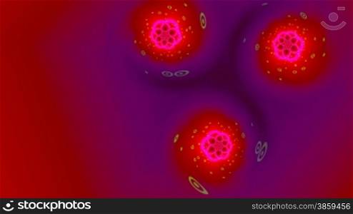 Three red shone full-spheres (flower) rotate against a dark background