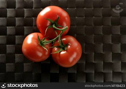 Three red tomatoes branch