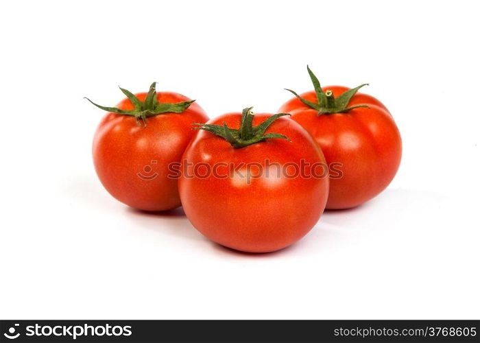 Three red tomatos isolated on white background