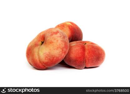 Three ripe fig peach isolated on a white background.