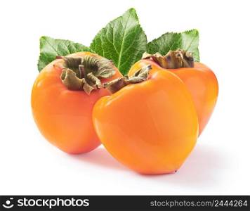 Three ripe juicy persimmons with a green leaves isolated on white background. Three ripe juicy persimmons with green leaves isolated on white background