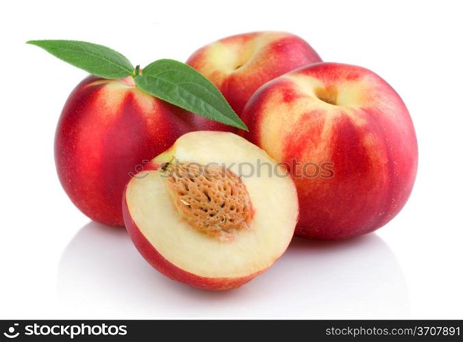 Three ripe peach (nectarine) fruits with slices isolated on white