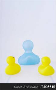 Three rubber ducks on a white background