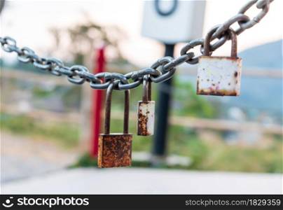 Three rusty padlocks with chain, Selective focus. Safety concept