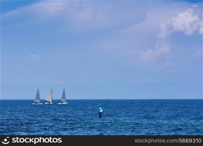 Three sailing centerboarder in open blue sea and fisherman&#xA;