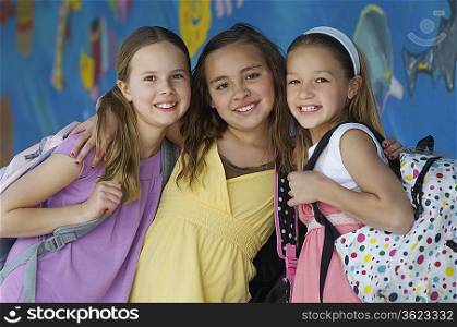 Three school girls outside school, portrait