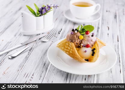 Three scoops of natural organic fruit ice cream in a wafer cup