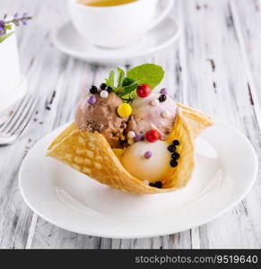 Three scoops of natural organic fruit ice cream in a wafer cup