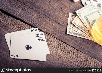 three, seven, ace playing card combination on a wooden table