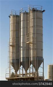 three silos. three silos of sand in a gravel pit operation