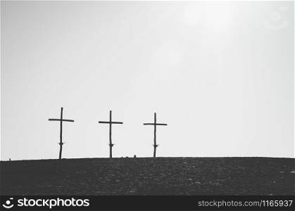 Three similar crosses on the horizont line in black and white. Three crosses on the horizont