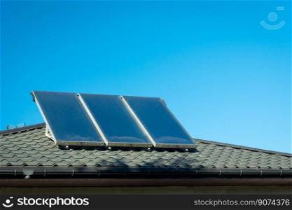 Three solar panels mounted on the roof and blue sky