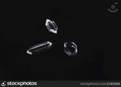 Three specimens of biterminated hyaline quartz on a black background