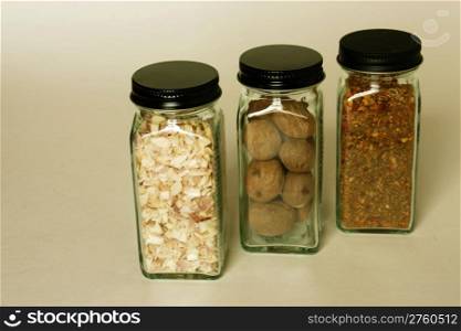 Three spices in similiar spice jars used in cooking