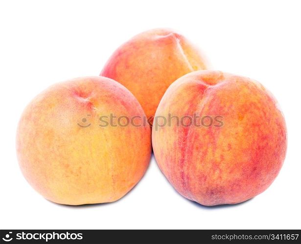 Three sweet juicy peaches isolated on white background