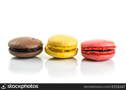 three Tasty colorful macaroons on white background