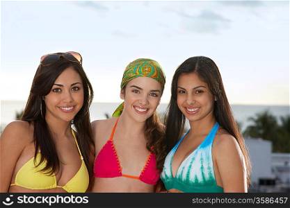 Three teenage girls (16-17) wearing bikinis portrait