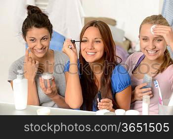 Three teenager girls enjoying getting ready in the bathroom