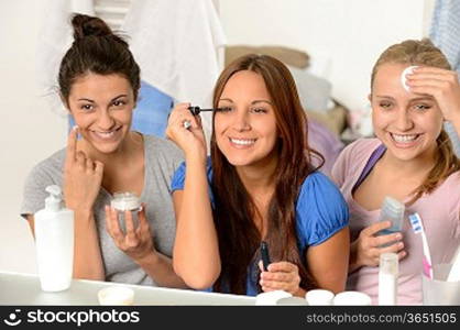 Three teenager girls enjoying getting ready in the bathroom