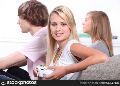 Three teenagers playing video games.