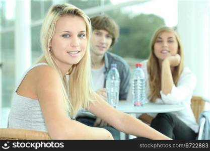 Three teenagers sat at a table