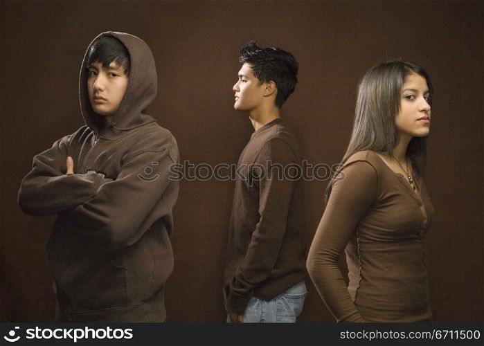 Three teenagers wearing brown