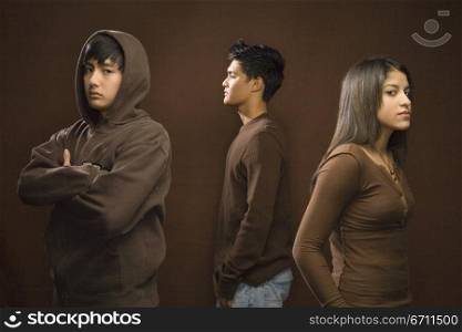 Three teenagers wearing brown