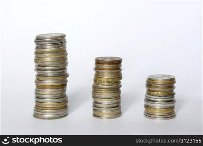 three towers of coins isolated on a whiteness
