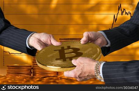 Three traders hands holding large bitcoin. Hands of three financial traders gripping bitcoin against a background of rising prices for the currency. Three traders hands holding large bitcoin