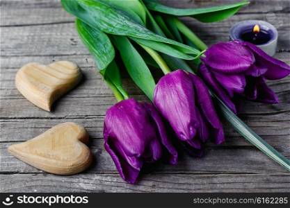 Three tulips and two symbolic hearts of wood. Tulip and hearts