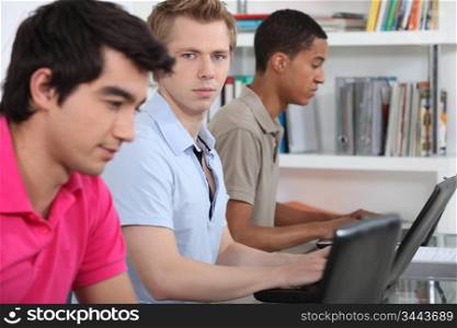 Three university students working on assignment