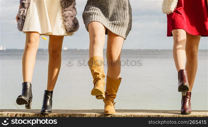 Three unrecognizable fashionable women wearing stylish shoes outdoor. Boots perfect for autumn and winter. Three women presenting shoes outdoor
