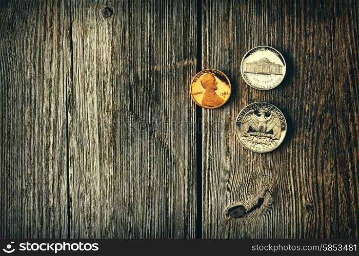 Three US cent coins over wooden background