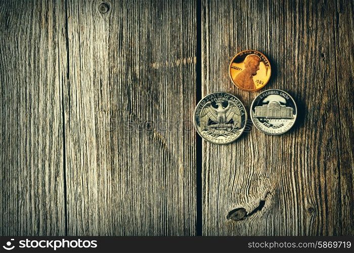 Three US cent coins over wooden background