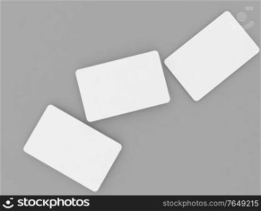 Three white business cards mock up on a gray background. 3d render illustration.. Three white business cards mock up on a gray background.