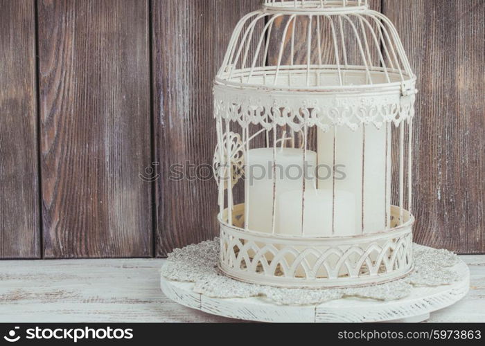 Three white Christmas candles inside bird cage. Shabby chic home decor. The Christmas candles