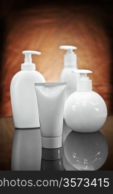 three white cosmetical sprays and tube