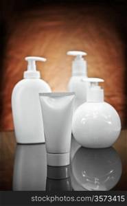 three white cosmetical sprays and tube