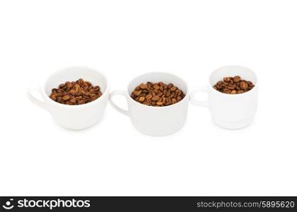 Three white cups full of coffee beans
